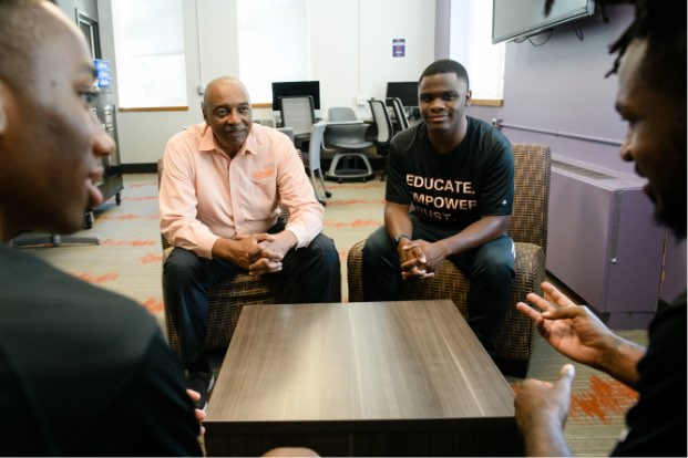 Roy sits in an academic building and talks with young men in the Call Me MISTER® program at Clemson. 