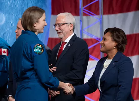 Vanessa shakes hands with a female astronaut
