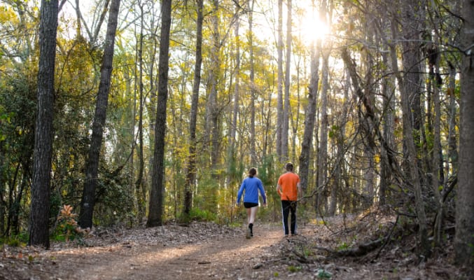 Two students walk together in the Clemson Experimental Forest. 