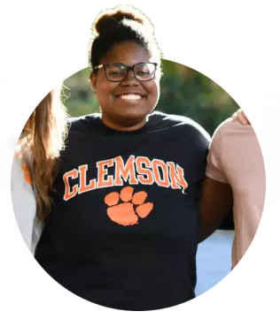 Student Terryn Witherspoon wears a navy sweatshirt with “Clemson” written in orange above the Tiger Paw.