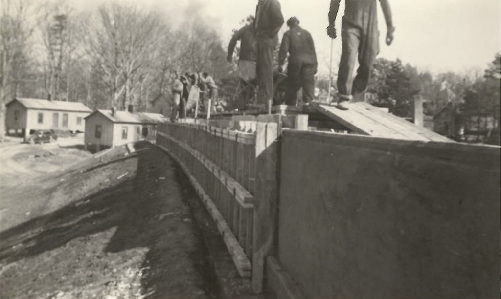 View of houses in the Bottoms neighborhood during construction of Memorial Stadium in 1941-42.