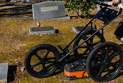 A GPR unit goes over the ground in Woodland Cemetery.