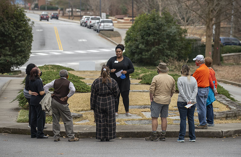 A group at the first stop of the cemetery tour at the entrance.