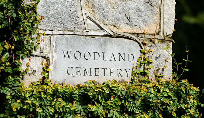 Stone entrance sign for Woodland Cemetery.