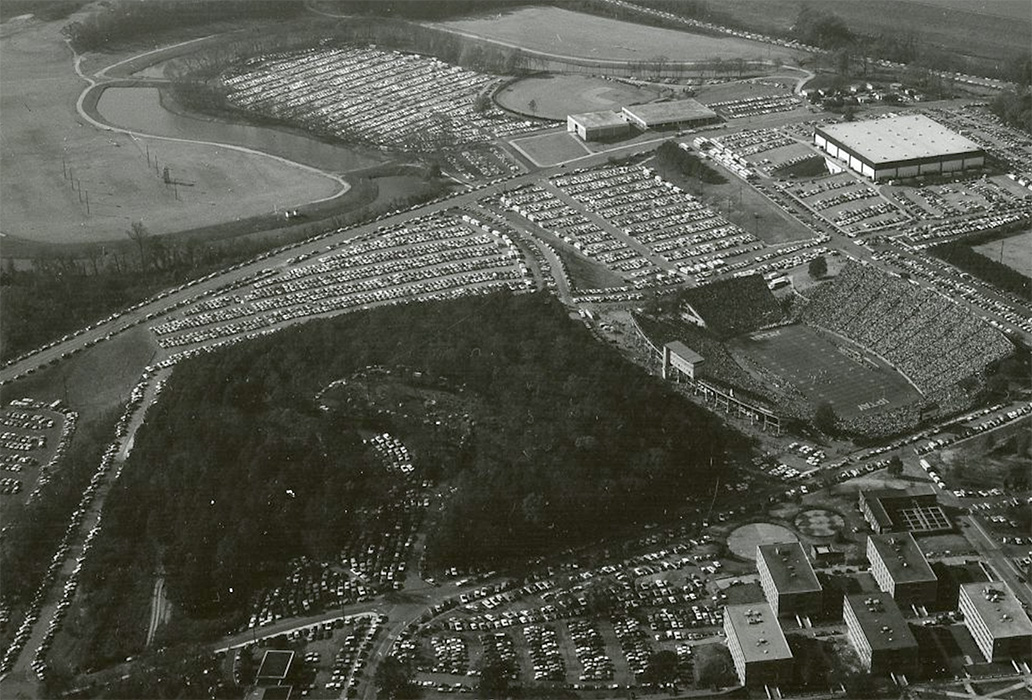 Cars are parked in Woodland Cemetery for tailgating during a home football game in 1974.