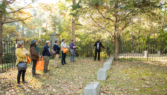 A guide gives a tour of the Calhoun Family Plot at Clemson.