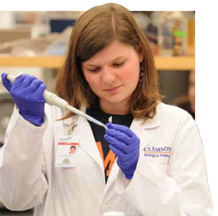 Jennifer is in a science lab observing the contents of a vial.