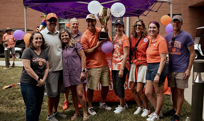 The 2022 NSP parents holding up their Natty Cup trophy at the 2023 NSP tailgate. 