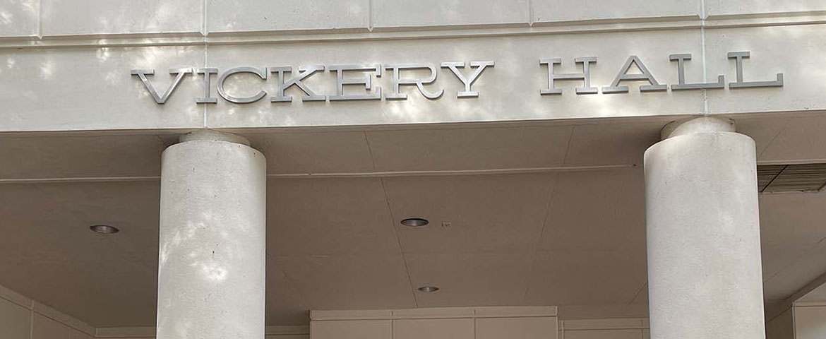 Silver letters spelling out Vickery Hall on the front of the building above white columns.