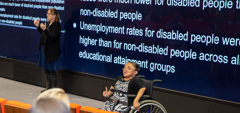 A person in a wheelchair giving a presentation