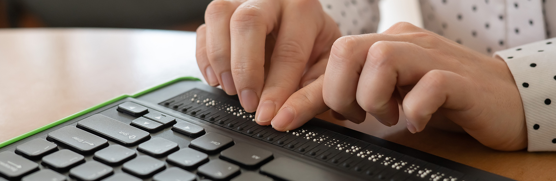 Fingertips interacting with a refreshable braille display