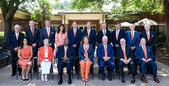 Board of Trustees members lined up in two rows outside