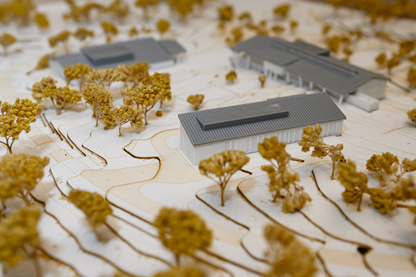 3d printed model of three buildings along with some trees
