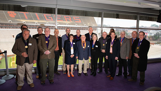 Faculty and Staff winners for the Award for Excellence in the President's suite of the football stadium.