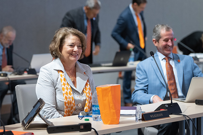 Chair Wilkerson and a colleague smiling while in a BOT meeting