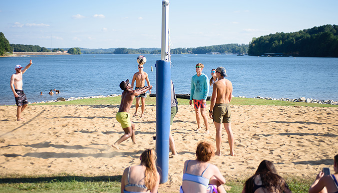 Group playing volleyball on the Y beach.