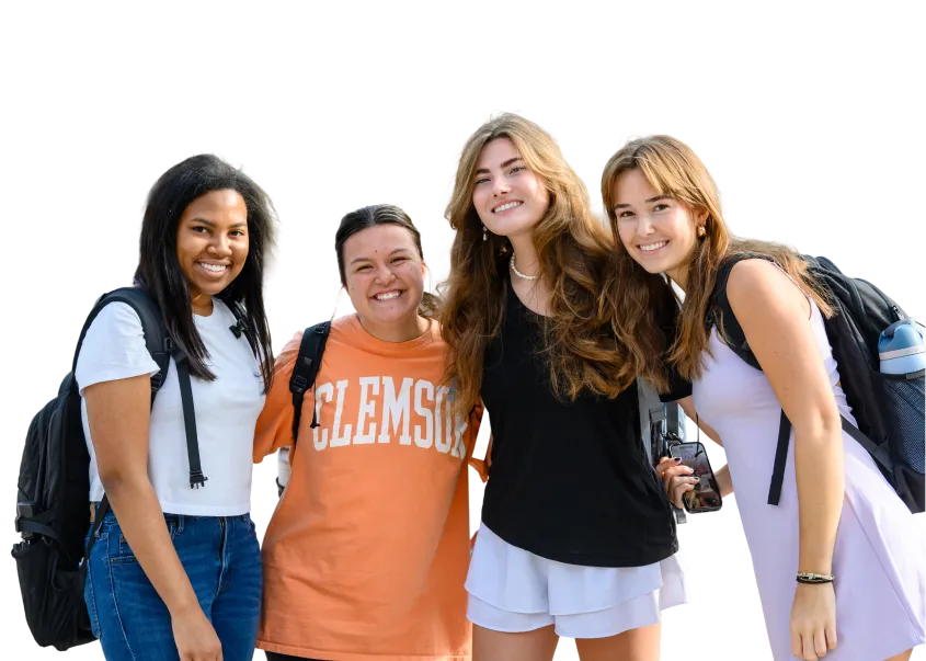 A cutout of four female students with backpacks posing together and smiling.