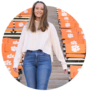 A female student walks down the clemson stands