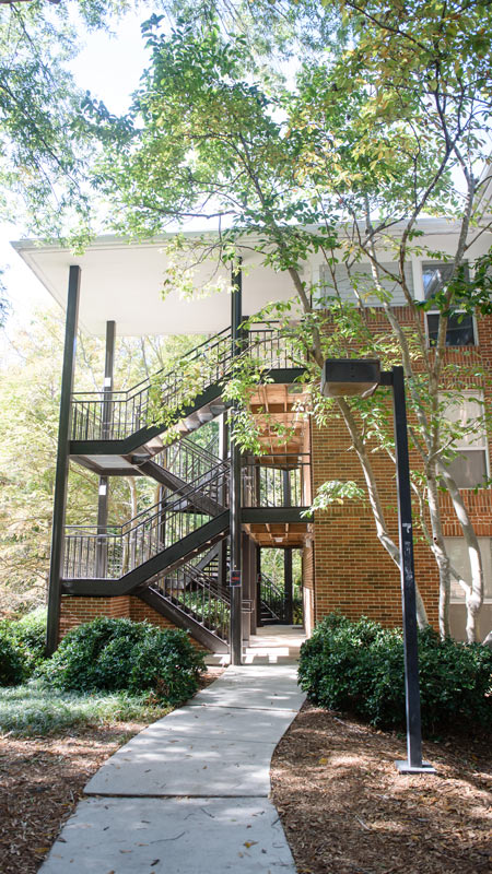 the exterior of lightsey bridge 1 showing a metal stair case and brick apartment building 