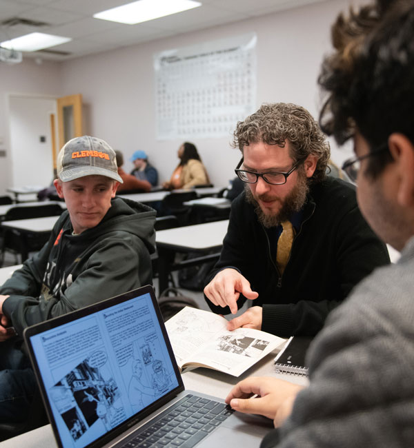 A TriCounty faculty member helps two students in a lab