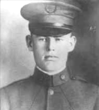 Black and white portrait of a young soldier in uniform, wearing a military cap and looking directly at the camera.