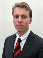 Headshot of a young man in a suit and tie, looking directly at the camera.