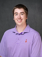 Studio headshot of a smiling young man wearing a purple striped polo shirt against a gray background.