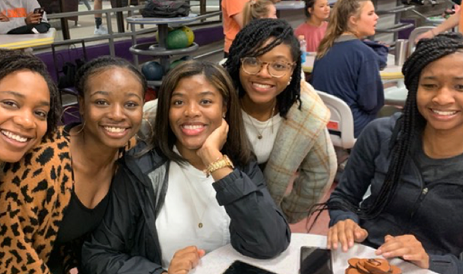 Five girls posing for photo.