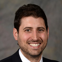Headshot of man with dark hair.
