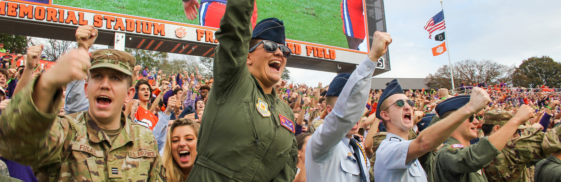 Cadets cheering at football game.