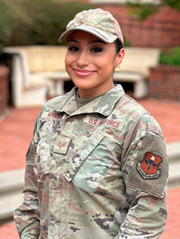U.S. Air Force service member smiling while in uniform outdoors.