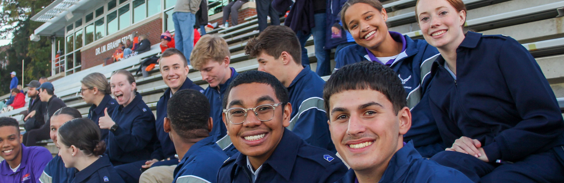 Cadets sitting on bleachers.