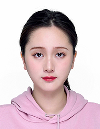 A portrait of a young woman with long dark hair wearing a light pink hoodie.