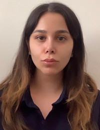 A portrait of a young woman with long, dark hair and a neutral expression.