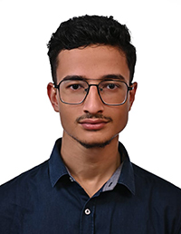 Professional headshot of a young man wearing glasses and a dark shirt.