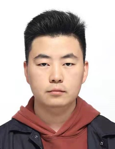 A young man with a neutral expression, wearing a burgundy hoodie under a dark jacket.