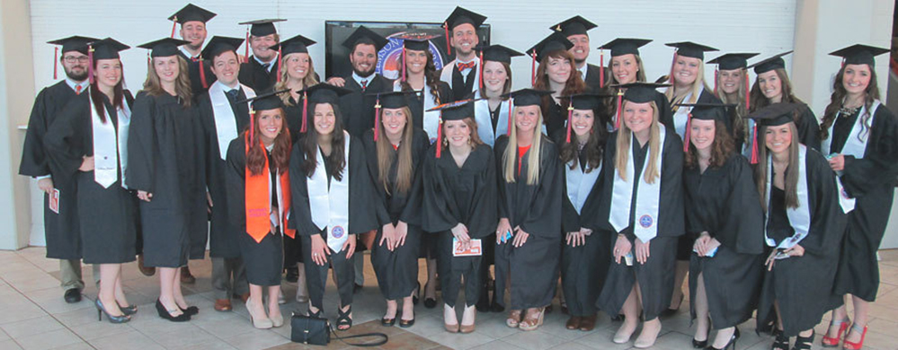 Group of graduating students in cap and gown.