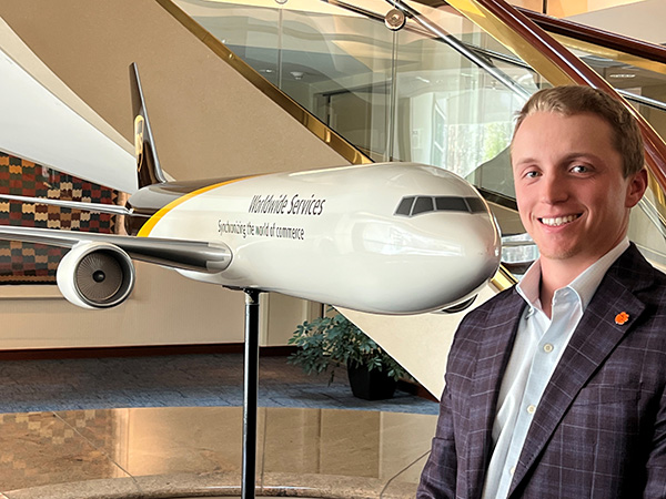 Justin Jones standing in front of airplane