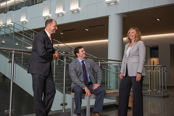 Chad Navis, Matt Hershel and Sharon Sheridan talking in new college building.