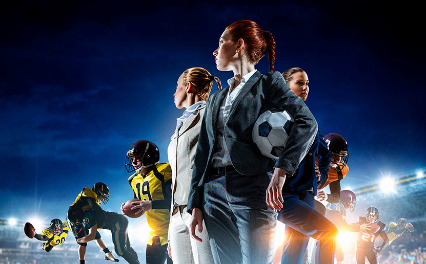 Women standing on football feild