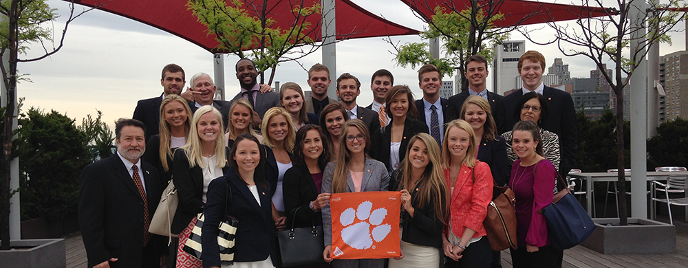 Group of people holding Clemson tiger rag.