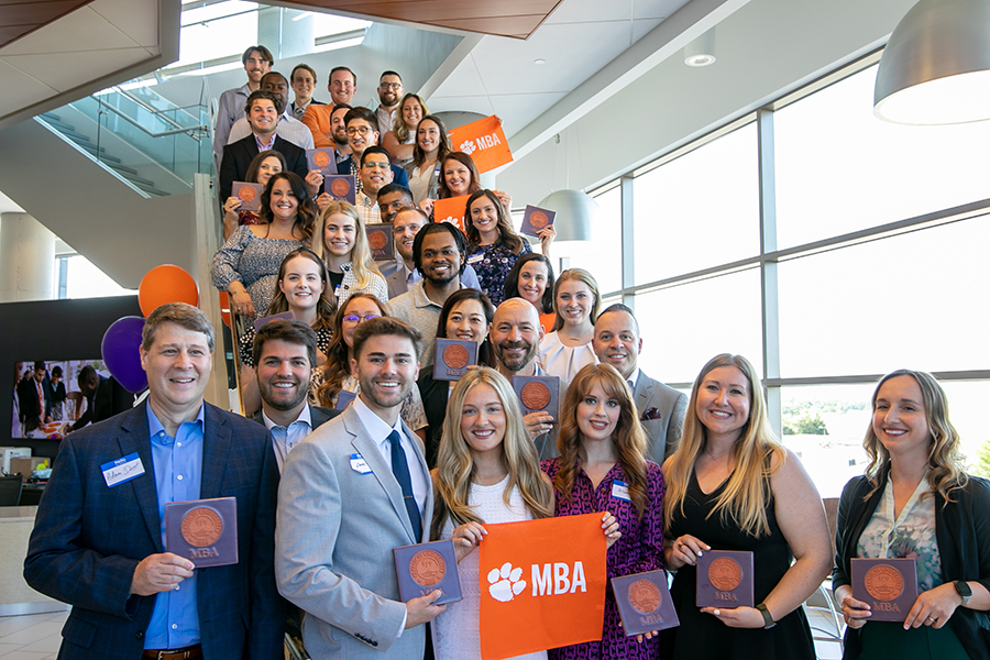 Group of students holding MBA tiles