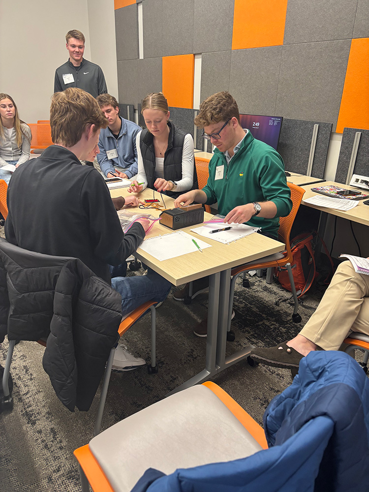 Students collaborating during a hands-on activity in a classroom setting.