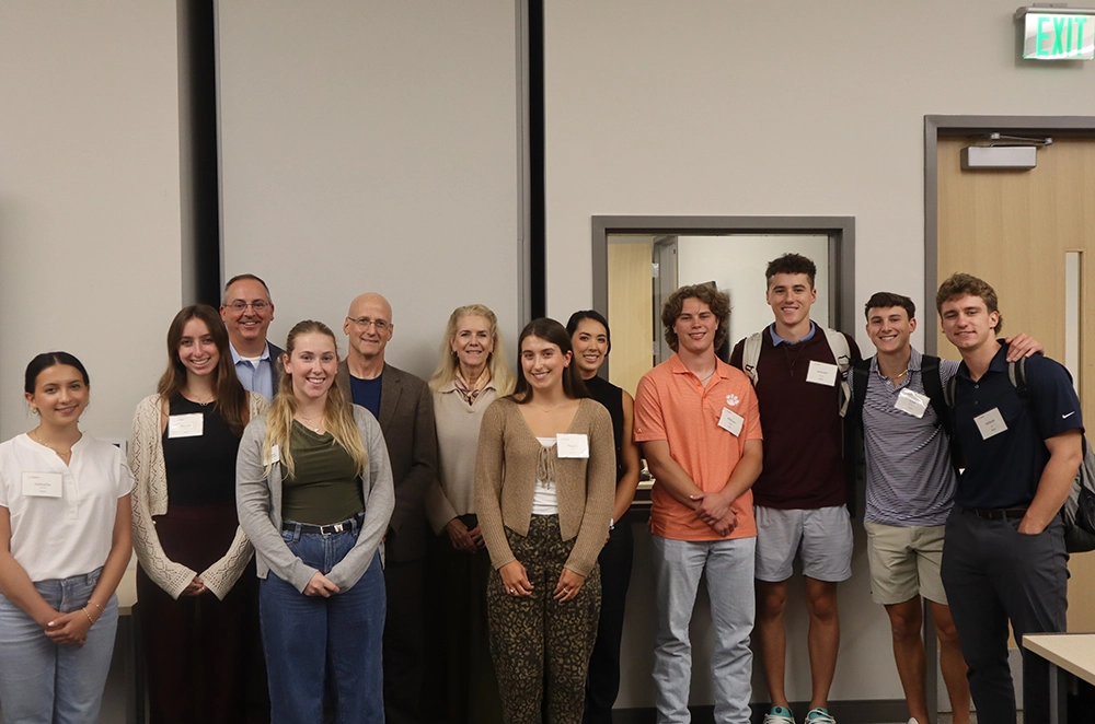 Group photo of students and faculty members posing together at an event.