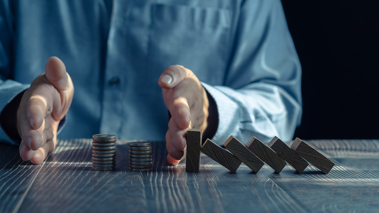 Hands with coins and blocks.