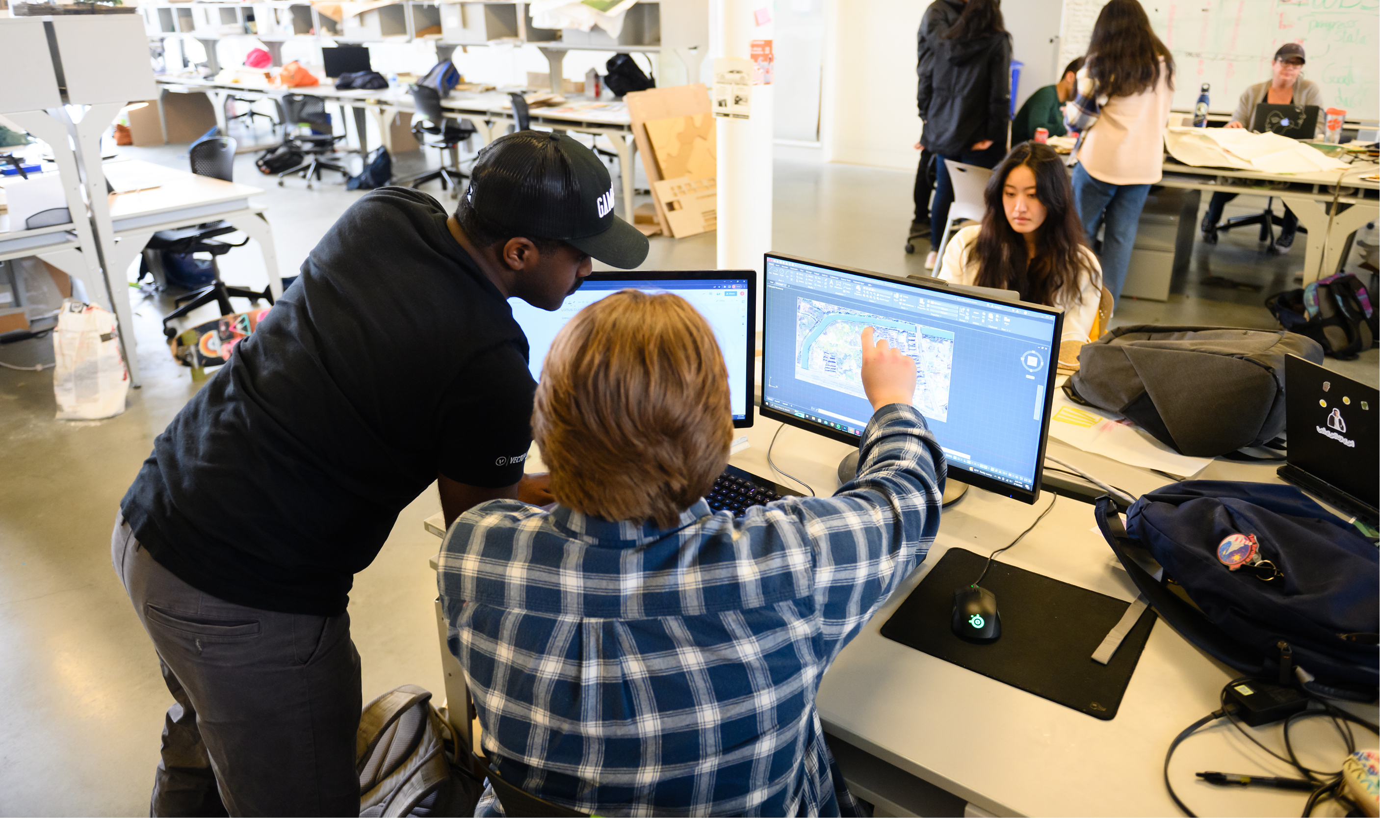 professor and student smiling while working