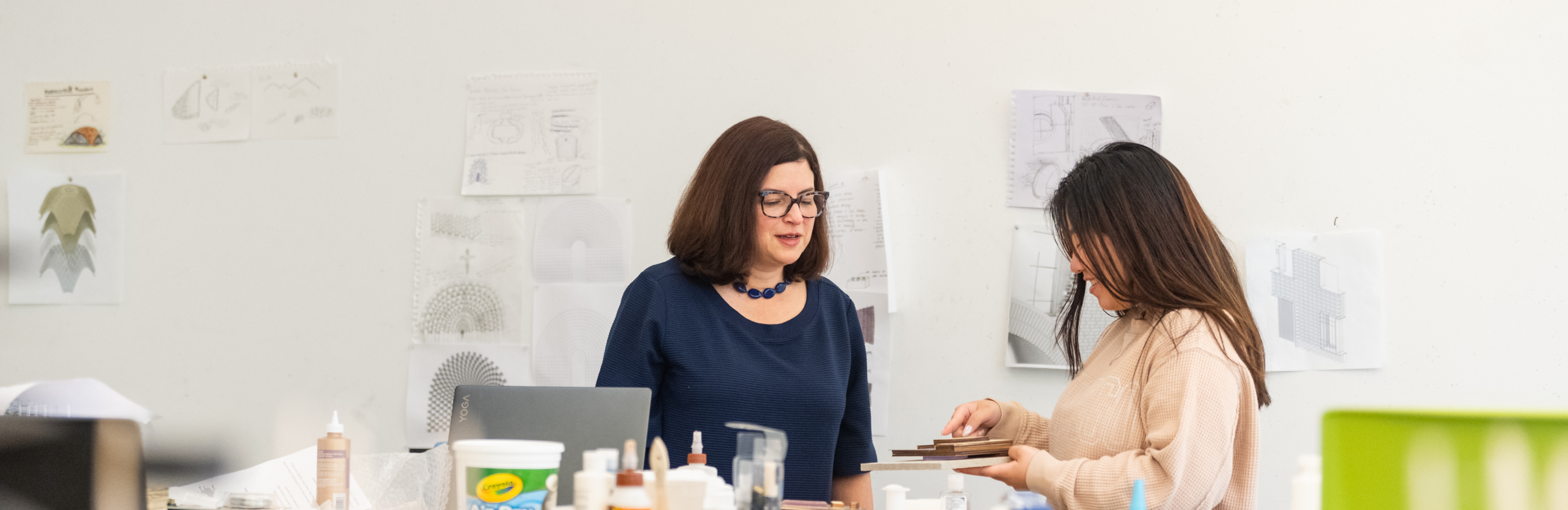 professors stand over architecture models
