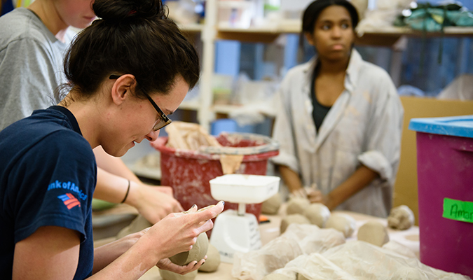 Image of art students creating pottery