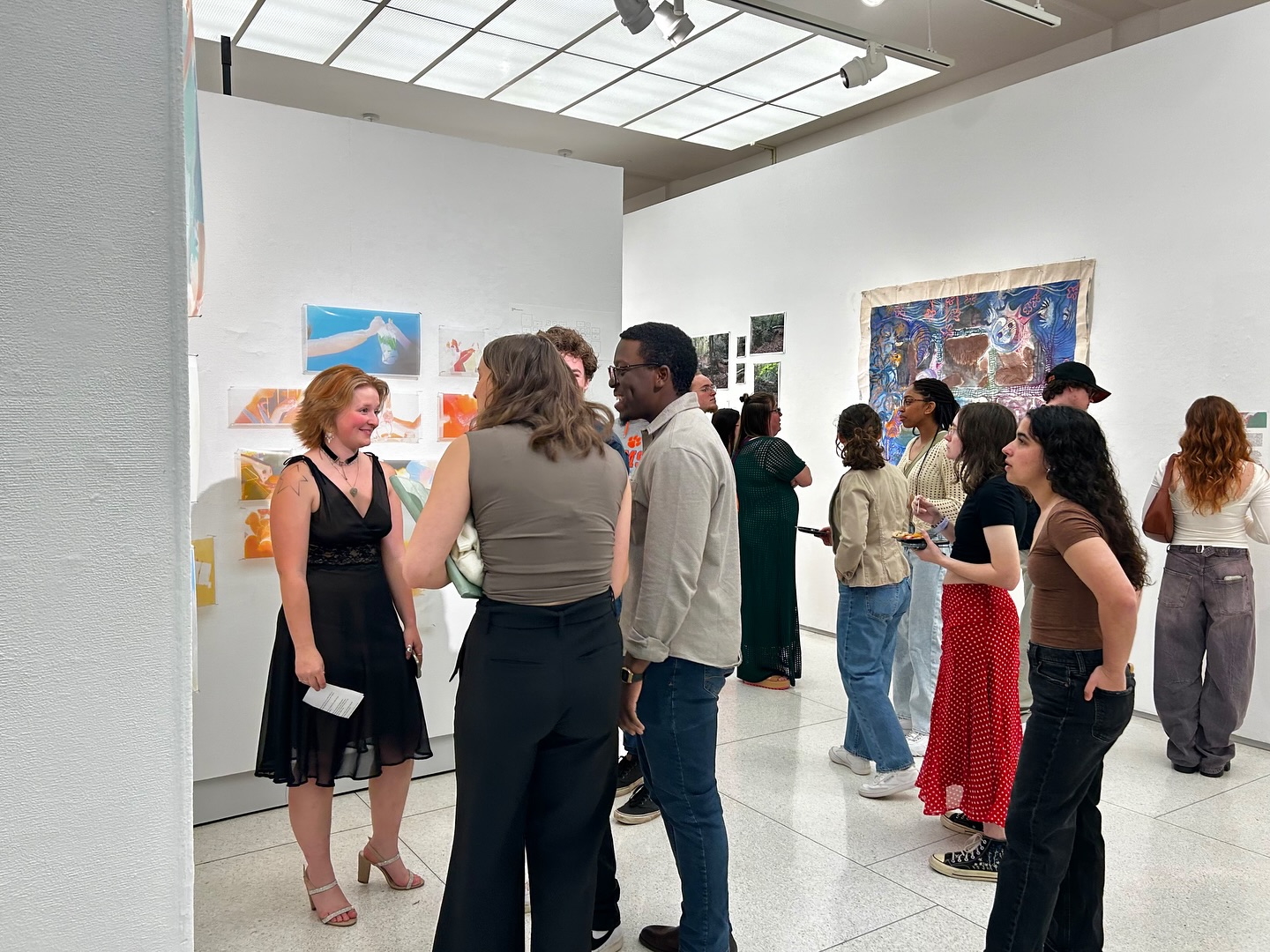Students and patrons gather in an art gallery