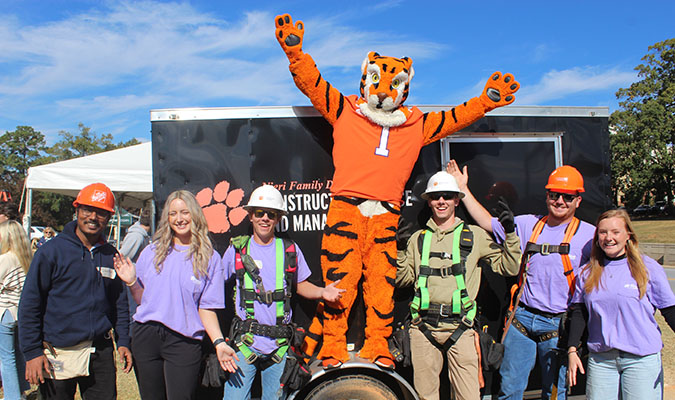 CSM students and tiger in front of CSM trailer